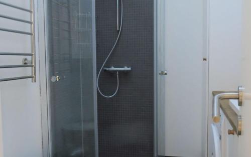 a bathroom with a shower with a glass door at ApartmentInCopenhagen Apartment 1323 in Copenhagen