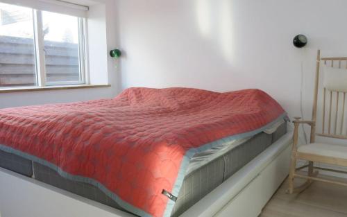 a bed in a room with a window and a chair at ApartmentInCopenhagen Apartment 1323 in Copenhagen