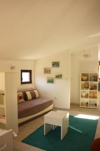 a bedroom with a bed and a table in it at Apartments Niković in Risan