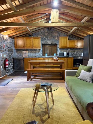a living room with a couch and a table at Casas da Peneda - Geres in Gavieira