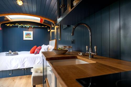 a kitchen with a sink and a bed in a room at Da Vinci's Den in North Tawton