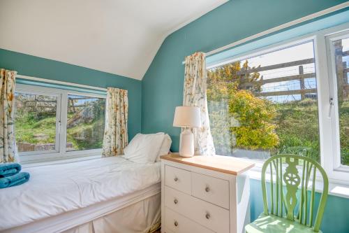 a bedroom with a bed and a window at 2 Caerau Isaf in Haverfordwest