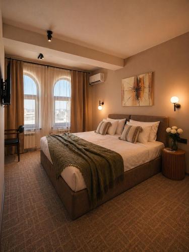 a bedroom with a large bed in a room at The Destan Hotel and Terrace in Baku
