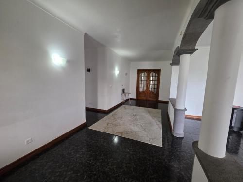 an empty room with a hallway with a door at Casa Pascoal in Ribeira Grande
