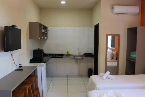 a room with a kitchen with a sink and a counter at Bela Vista Japaratinga Flats e Temporada in Japaratinga