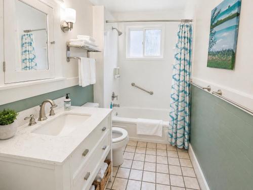 a white bathroom with a sink and a toilet at Boulevard Park Apartments in Erie
