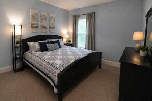 a bedroom with a large bed and a window at Boulevard Park Apartments in Erie