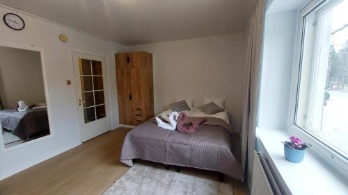 a small bedroom with a bed and a mirror at Modern studio apartment near the harbor and city center in Lappeenranta