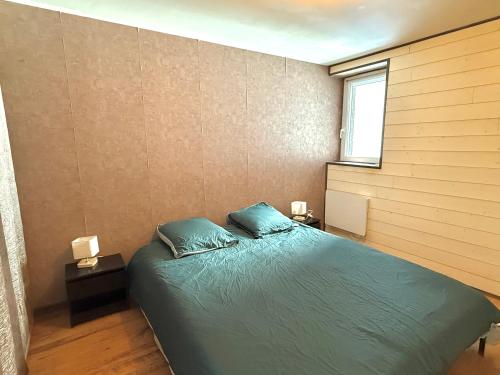 a bedroom with a bed with two pillows on it at Le Fonctionnel - Central in Mâcon