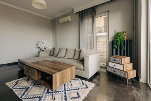 a living room with a couch and a coffee table at Panoramic Apartment in Chios