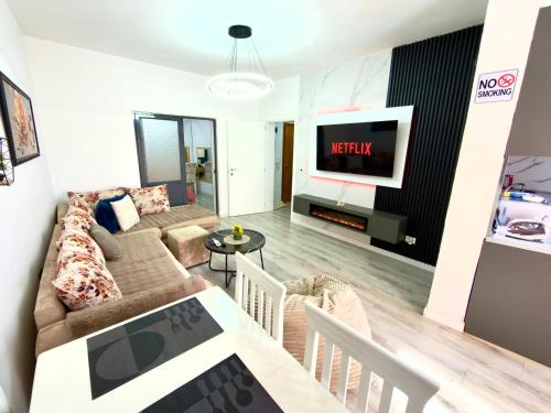 a living room with a couch and a tv at Boku Apartments Pazari i Ri 2 in Tirana