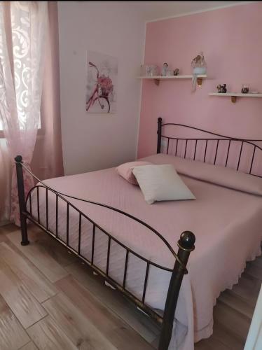 a bedroom with a black bed with a white blanket at Casa Scopelliti Calasetta in Calasetta