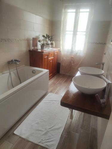 a bathroom with a tub and a sink and a toilet at Casa Scopelliti Calasetta in Calasetta