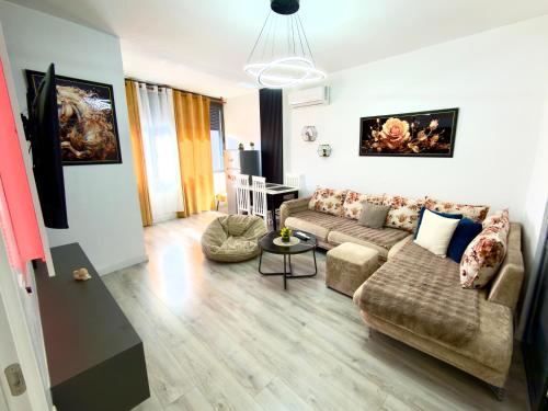 a living room with a couch and a table at Boku Apartments Pazari i Ri 2 in Tirana