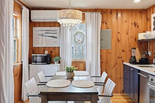 a dining room with a table and chairs in a kitchen at The Coast: Cozy Cape Escape in Dennis Port in Dennis Port