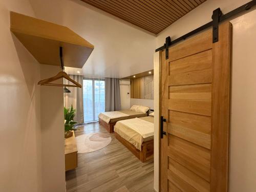 a room with a door leading to a bedroom at The Beach House by SYNCO in Lubong