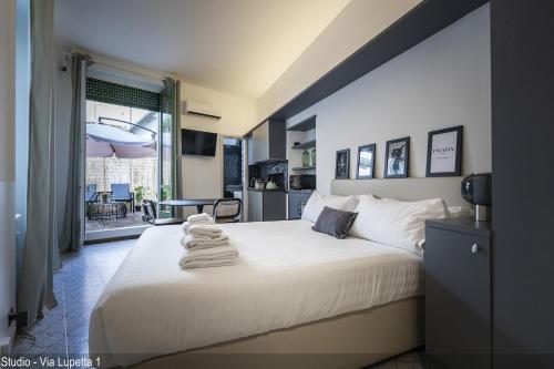 a bedroom with a large bed with towels on it at Brera Apartments in Duomo in Milan