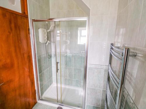 a shower with a glass door in a bathroom at Ocean View in Westport