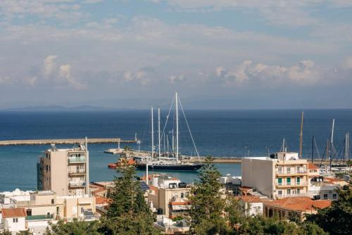 a city with a harbor with boats in the water at Panoramic Loft in Chios