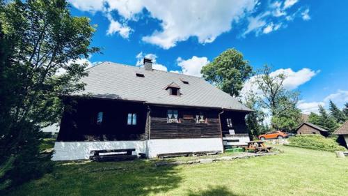 a large house with a yard with a grassy yard at U Jakuba - Boba in Prášily