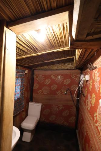a small bathroom with a toilet and a sink at Noble Cheer in Ruhengeri