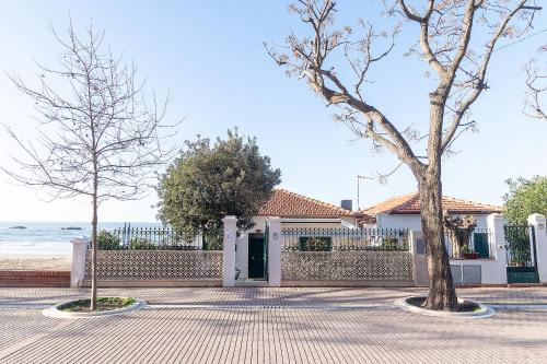a house with two trees in front of it at Villa in Spiaggia in Follonica
