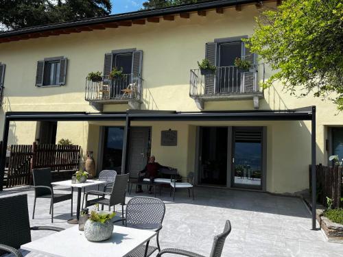 a patio with tables and chairs in front of a building at B&B La Lanterna in Verbania