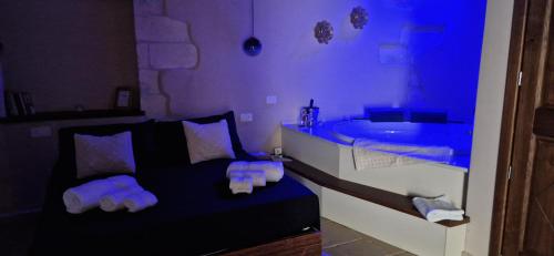 a bathroom with a black bed and a sink at Il Lentisco in Codrongianos