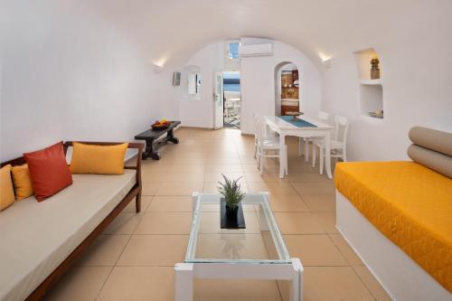 a living room with a couch and a table at ROCK CAVE HOUSE in Oia