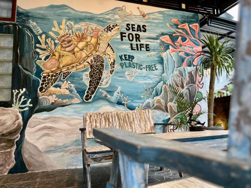 a wall with a painting of a turtle on it at Terima Kasih Malang Hostel in Malang