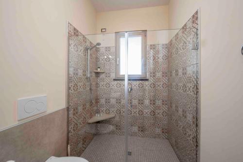 a bathroom with a shower with a toilet and a window at Coastal Escape, Amalfi in San Lazzaro Agerola