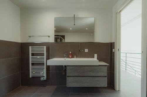 a bathroom with a sink and a mirror at Villa Ryx avec piscine in Grimaud