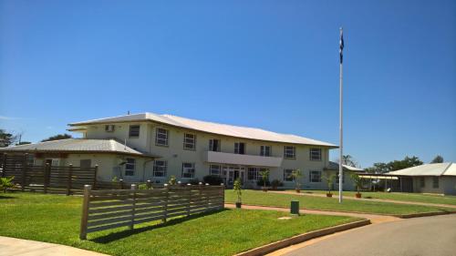 a large white house with a fence in front of it at Kernow - Minimum age 18 in Charters Towers