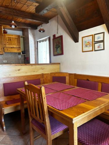 a dining room with a wooden table and chairs at Bovec Center Stay in Bovec