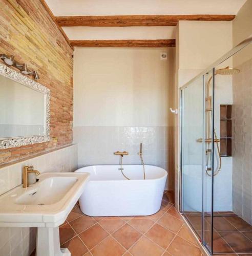a large bathroom with a tub and a shower at Can Passarells in San Vicente de Torelló