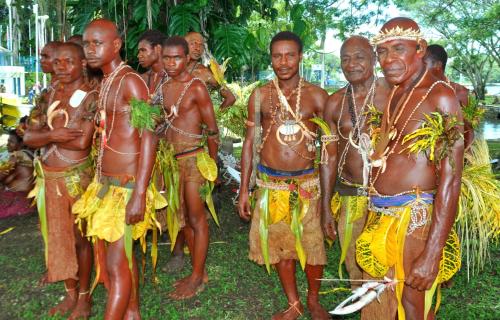 a group of men dressed in tribal costumes at Madang Resort in Madang