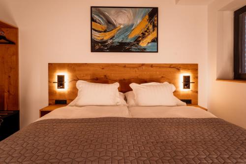 a bedroom with a large bed with two white pillows at Posestvo Gjerkeš in Rogašovci