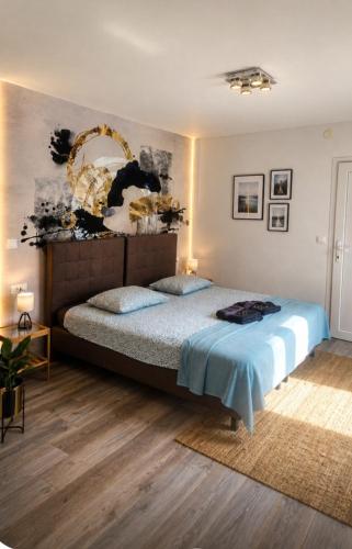 a bedroom with a bed with a blue bedspread at Villa Heaven Green in Pazin