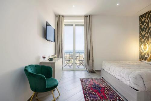 a bedroom with a bed and a chair and a window at Sant'Erasmo luxury home in Palermo