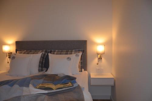 a bedroom with a bed with a book on it at Spokojnia in Lubrza