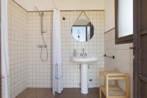 a bathroom with a sink and a mirror at La Pedrosa in La Cimada