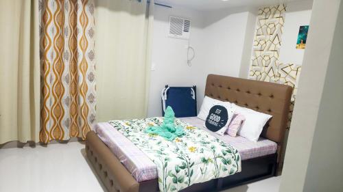 a bedroom with a bed with a teddy bear on it at Onelakeshore back smx lanang in Davao City