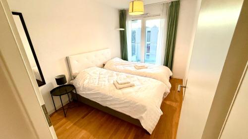 a small bedroom with a bed and a window at Cape Homes St-Sulpice in Saint-Sulpice