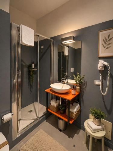 a bathroom with a sink and a shower at Hotel La Costiera in Varcaturo