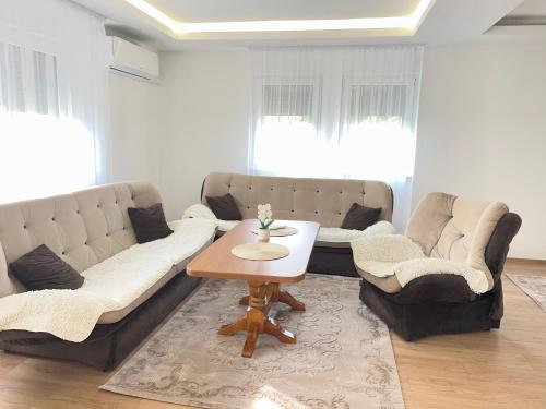 a living room with a couch and a table at Al Noor Villa Ilidža in Ilidža