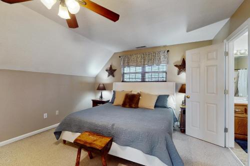 a bedroom with a bed and a ceiling fan at Hot Tub & Stunning Views! Hayesville Retreat in Cedar Cliff