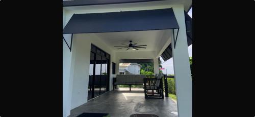 a house with a blue awning on a patio at Purevibe Horizon House Ocean View Villa Port Antonio in Port Antonio