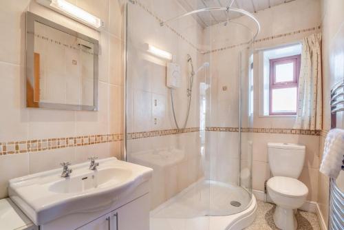 a bathroom with a sink and a shower and a toilet at 6 Bed in Blackburn oc-c38221 in Balderstone