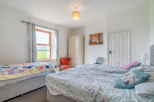 a bedroom with two beds and a window at 6 Bed in Blackburn oc-c38221 in Balderstone