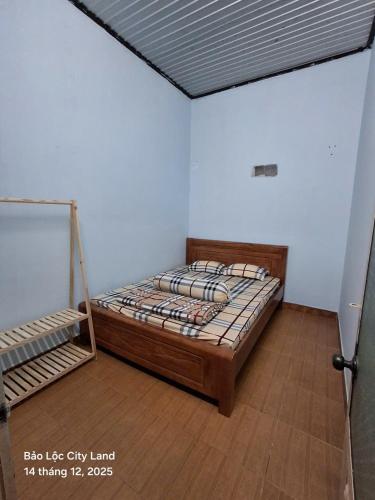 a bedroom with a bed in a room at Lương Y Trần Thúy Liên in Bảo Lộc